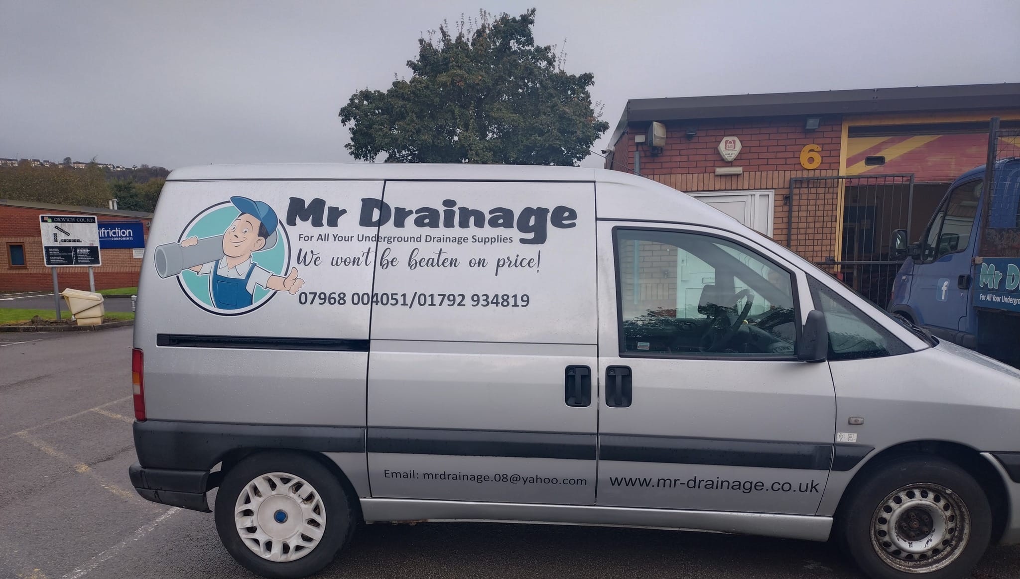 The Mr Drainage van parked outside their unit
